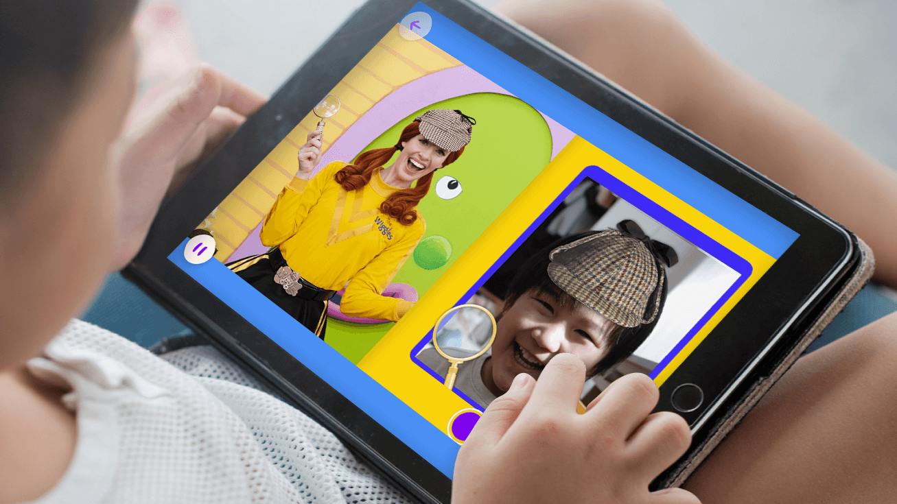 Child playing Hellosaurus on an iPad.